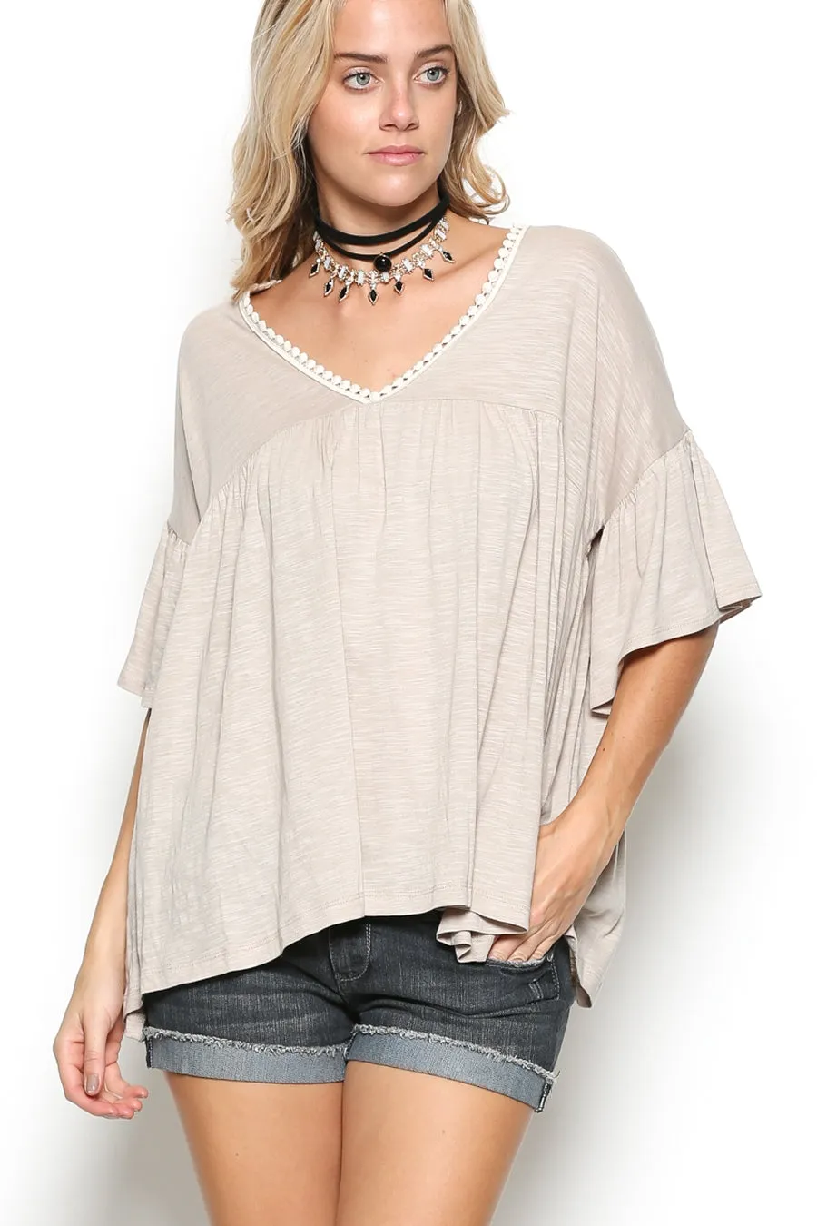 Delicate casual ruffle tunic with lace detail and half dolman sleeve